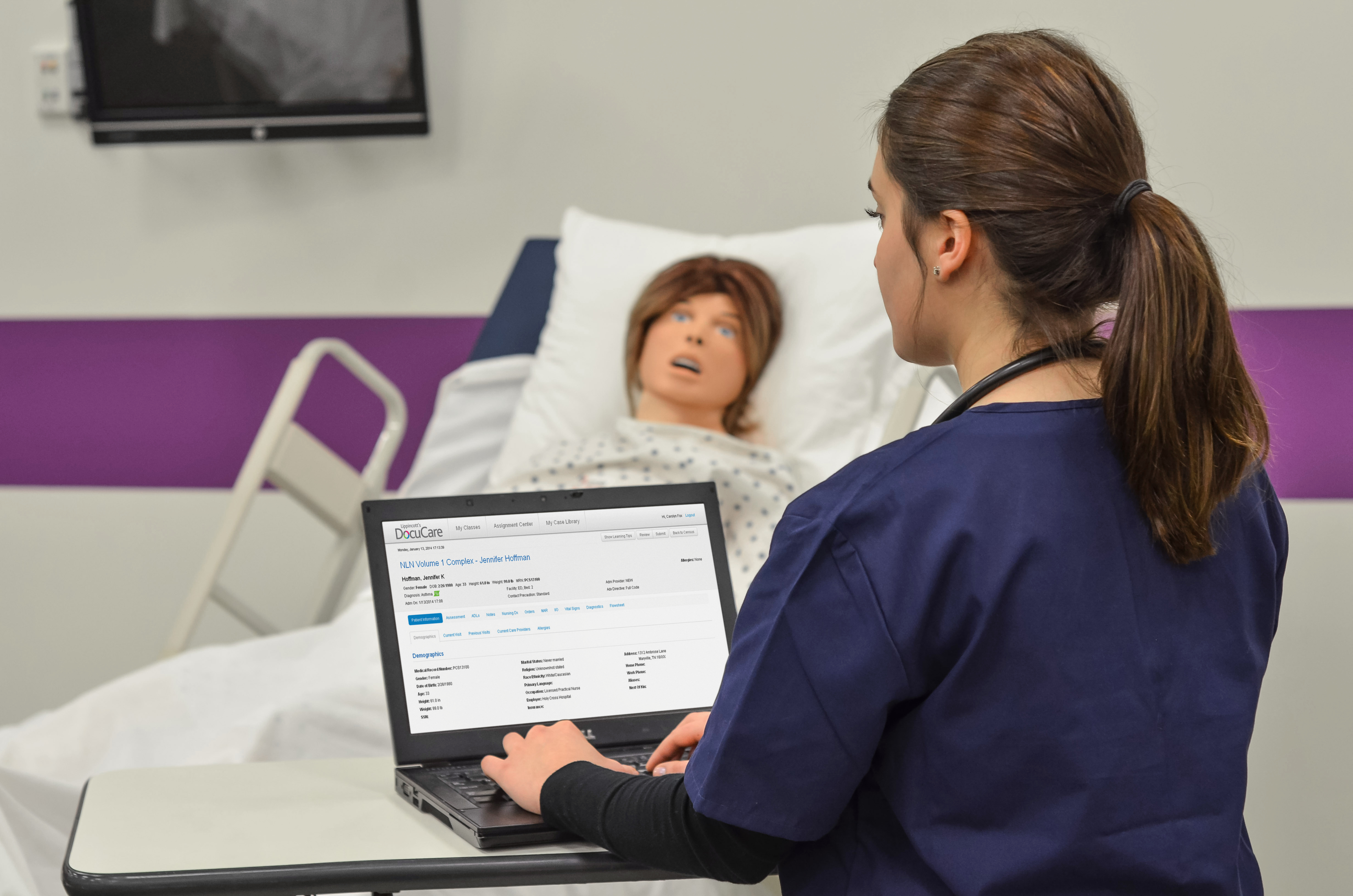 Nurse using lippencott with simulator manikin