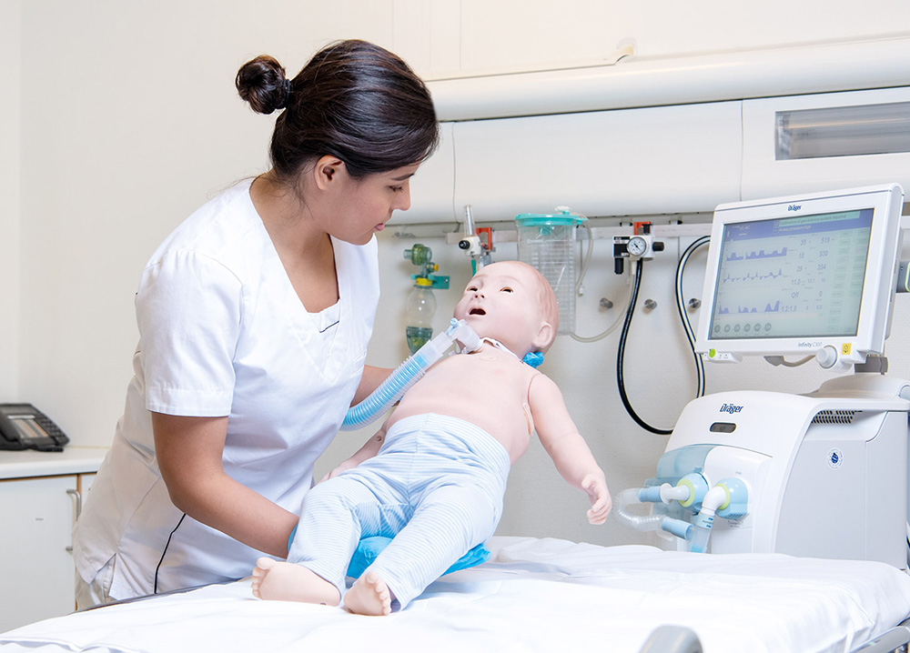 SimBabyTrach_holdingNurse.jpg