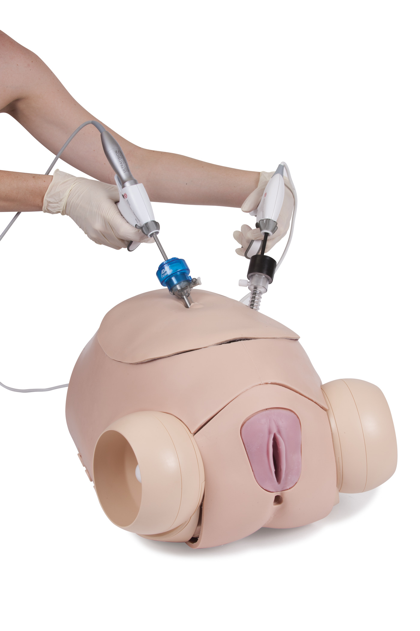 surgical_female_pelvic_trainer__sfpt__mk_2_hands_on_instruments_through_throunds_belly_60251_1400x2100_300_rgb.jpg